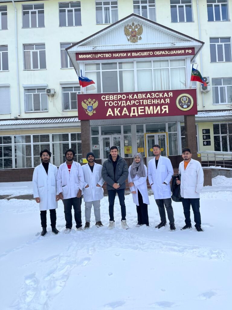 a group of people in white coats in front of a building